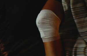 Injured knee with bandage, Photo by Alexey Demidov