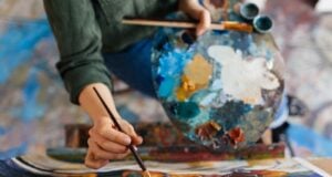 View of an artist painting with oil paints.