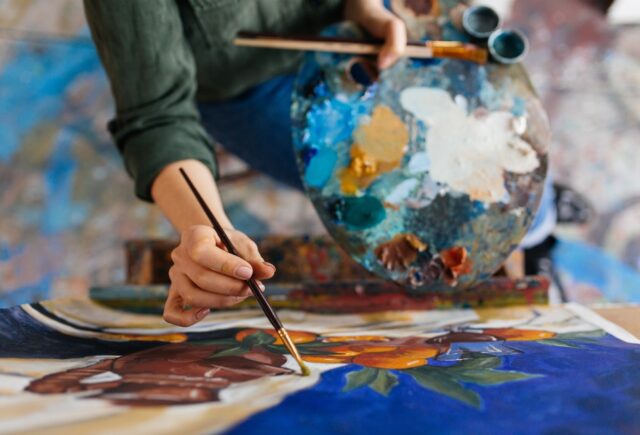 View of an artist painting with oil paints.