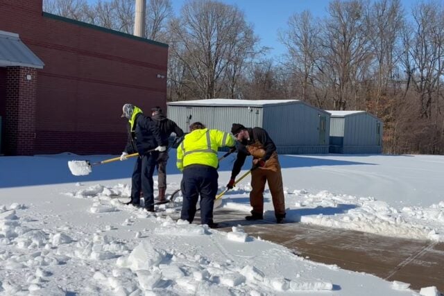 Public works employees helping clean off a walkway to LES during the winter weather event Lakeland experienced this past winter.